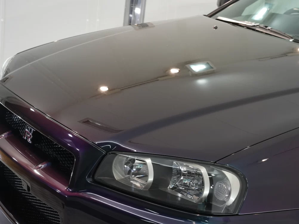 天井の照明が鏡のようにくっきりと映り込むR34 GT-Rのボンネット 兵庫県尼崎市kiramek